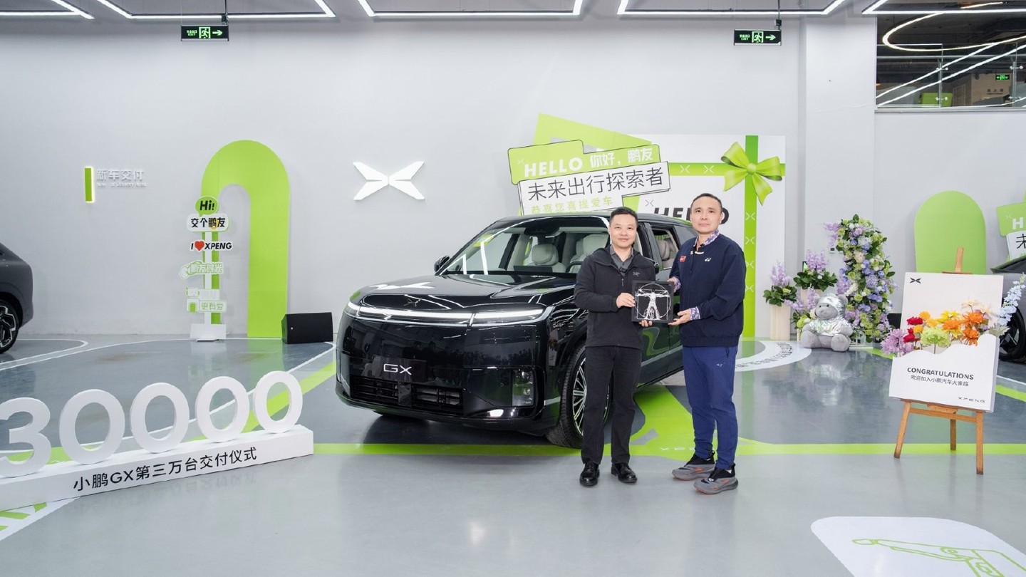 Xpeng chairman and CEO He Xiaopeng, left, marks the delivery of GX vehicle No. 30,000 at the company's Yizhuang delivery center in Beijing on October 22, 2026. Credit: Xpeng