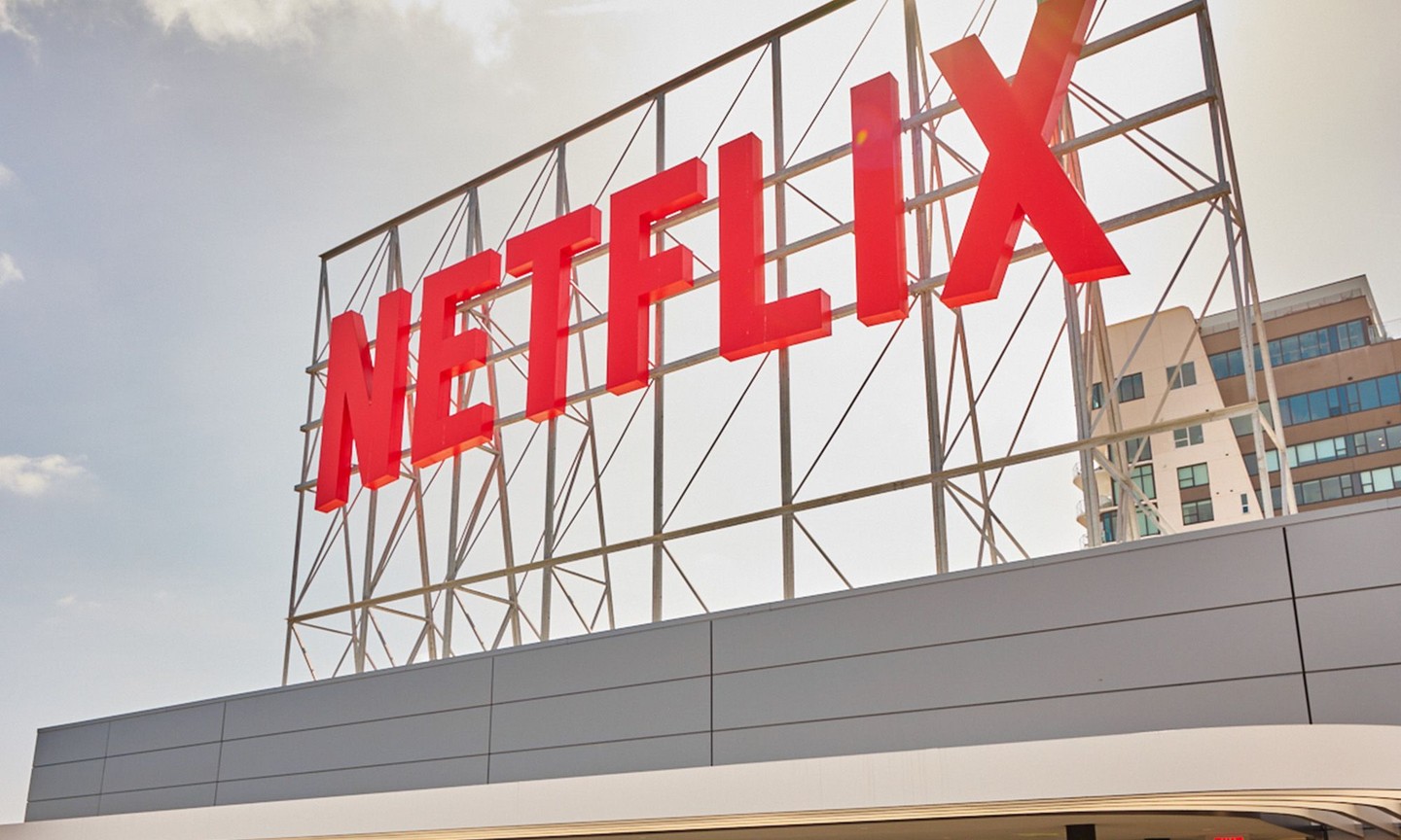 A large Netflix logo sign on top of a building.