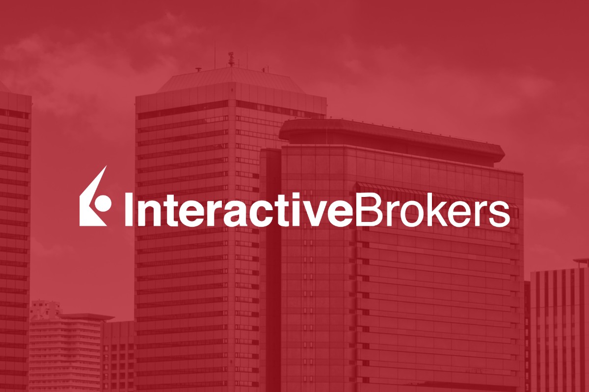 The Interactive Brokers logo over a red-tinted city skyline.