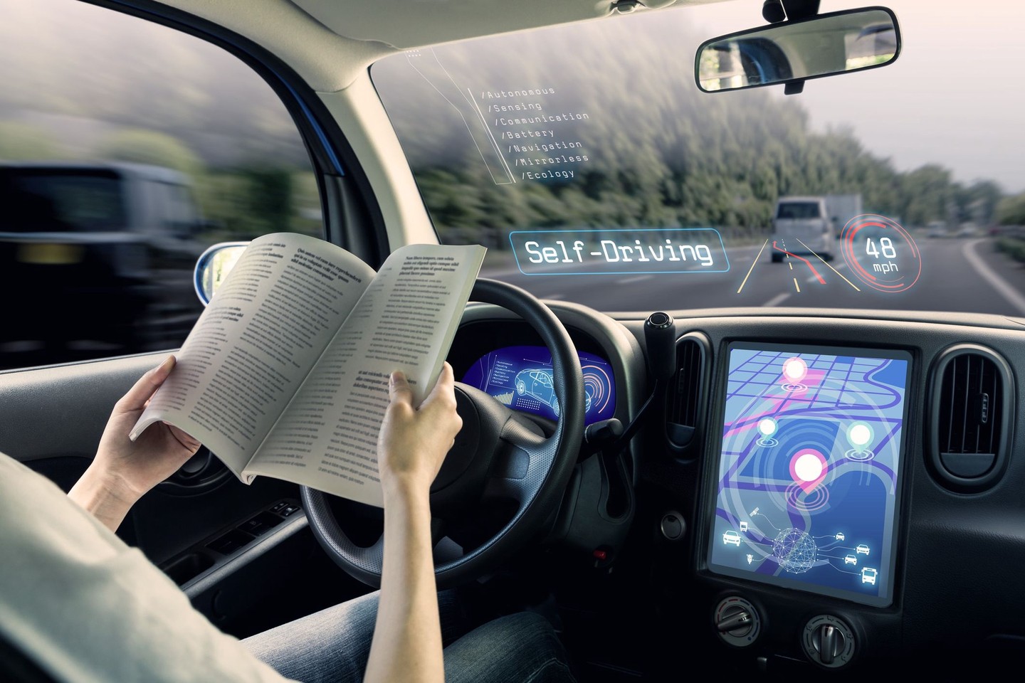 A person reads a magazine behind the wheel of a self-driving car.