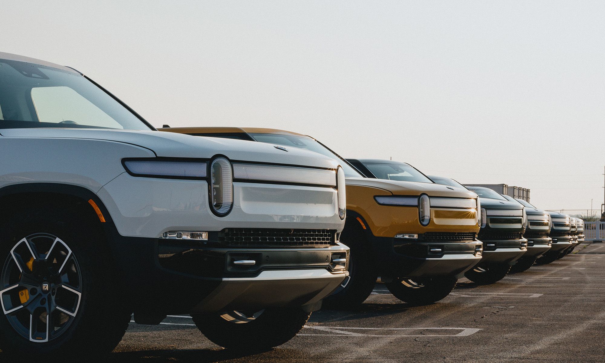 Rivian vehicles parked in a parking lot.