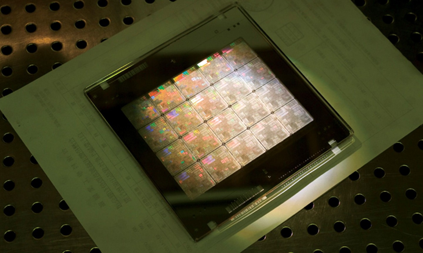 A panel of semiconductor chips on a perforated table.