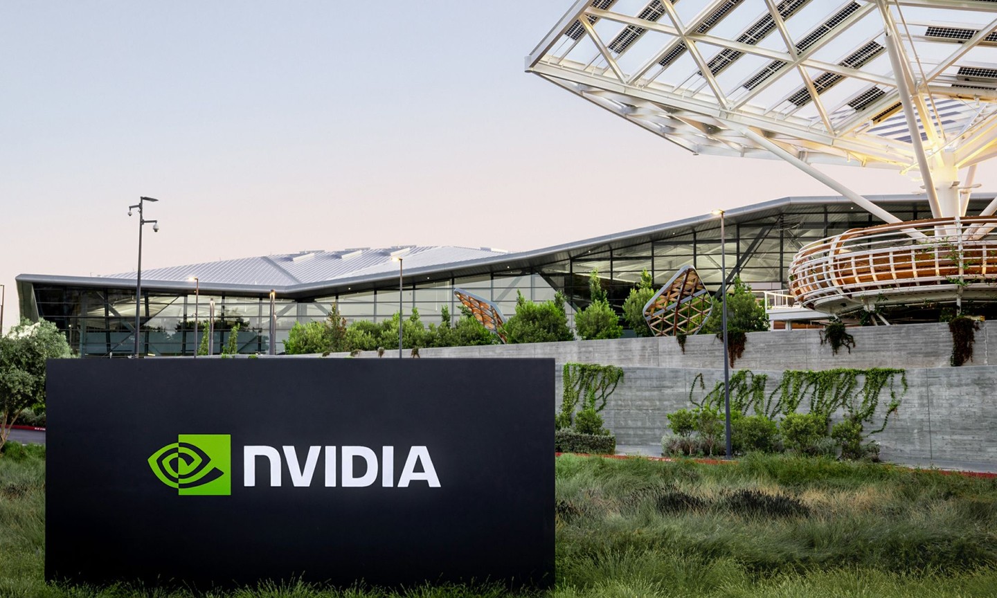 NVIDIA headquarters exterior with modern glass architecture and large NVIDIA logo sign in landscaped campus