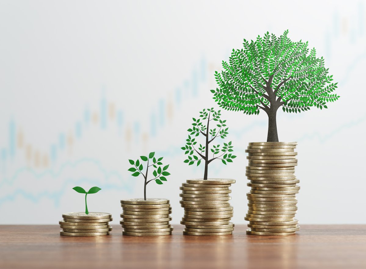 Stacks of gold coins with trees sprouting out of the top of each stack.