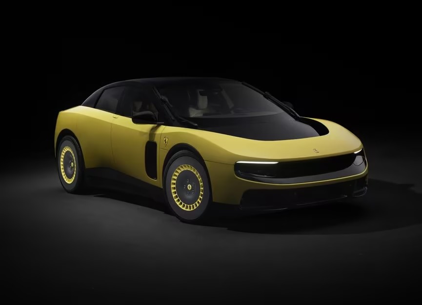 A yellow Luce, Ferrari's first full-electric vehicle, against a black background.