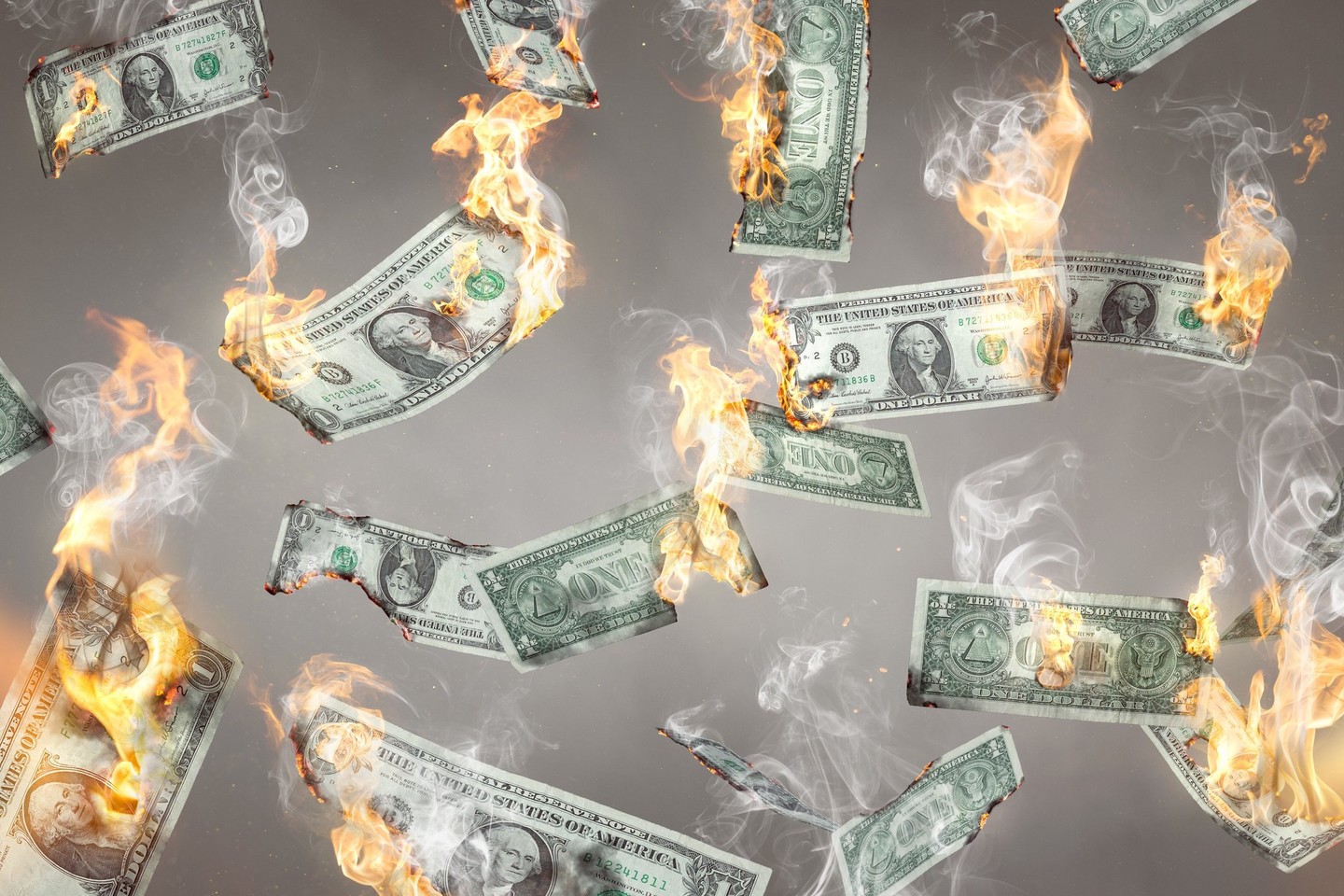 US dollar banknotes on fire and falling down.