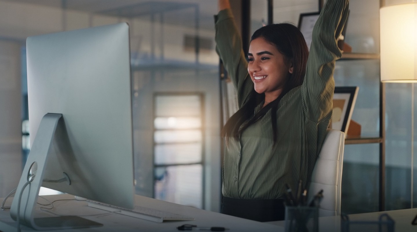 Someone celebrating what she's seeing on her computer screen.